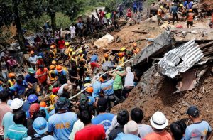 Praying for miracles, rescuers seek signs of life after Philippine typhoon landslides
