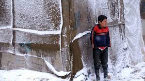 Syrian refugees in Lebanon bundle up against storm