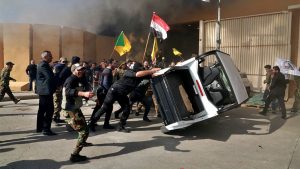 US Embassy compound in Baghdad under siege as crowds protesting airstrikes break through gate