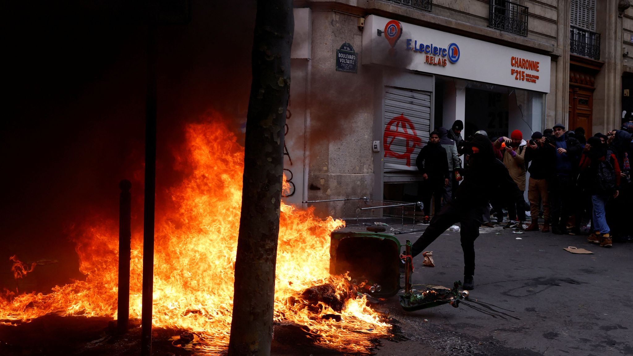 France pension protests latest: Violence grows in Paris as protesters smash shops and riot police storm streets